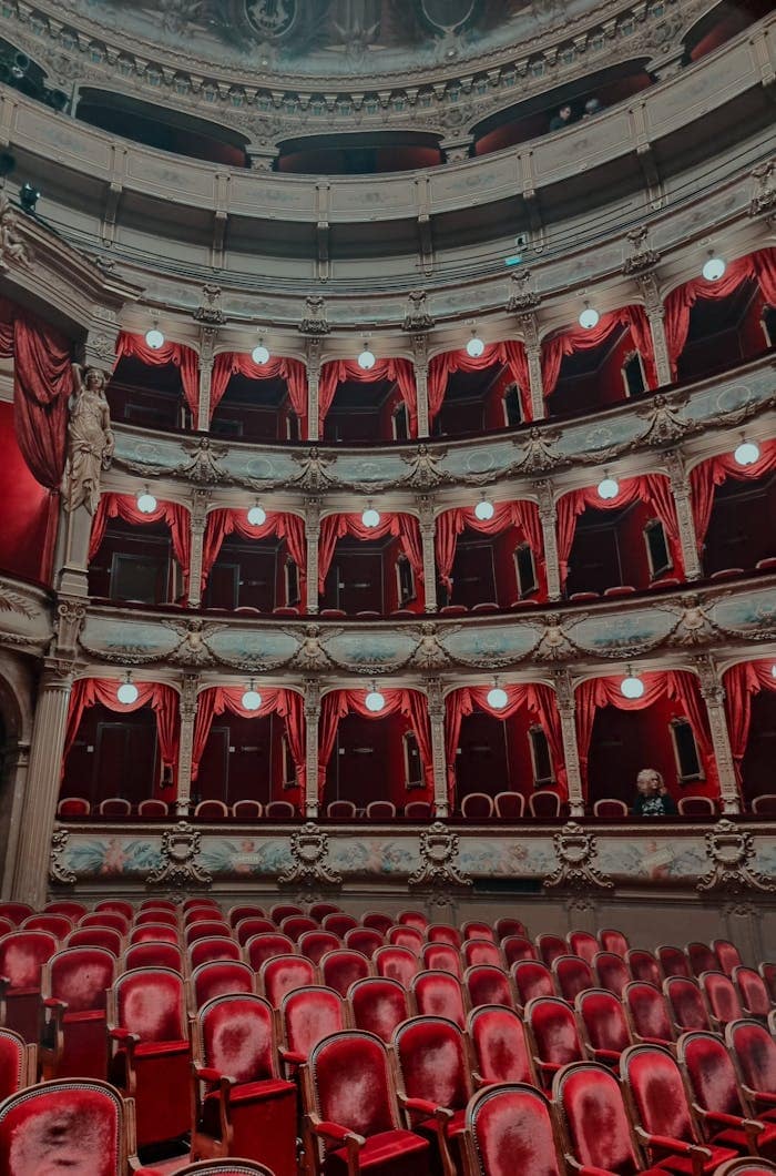 A stunning view of the ornate interior of the Opera de Nice in France, featuring red velvet seating.
